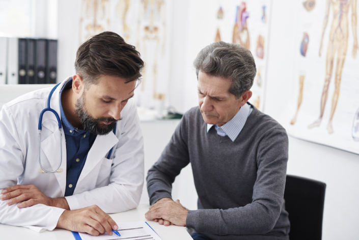Analyzing the medical results in doctor office Men working on bookkeeping for a medical practice