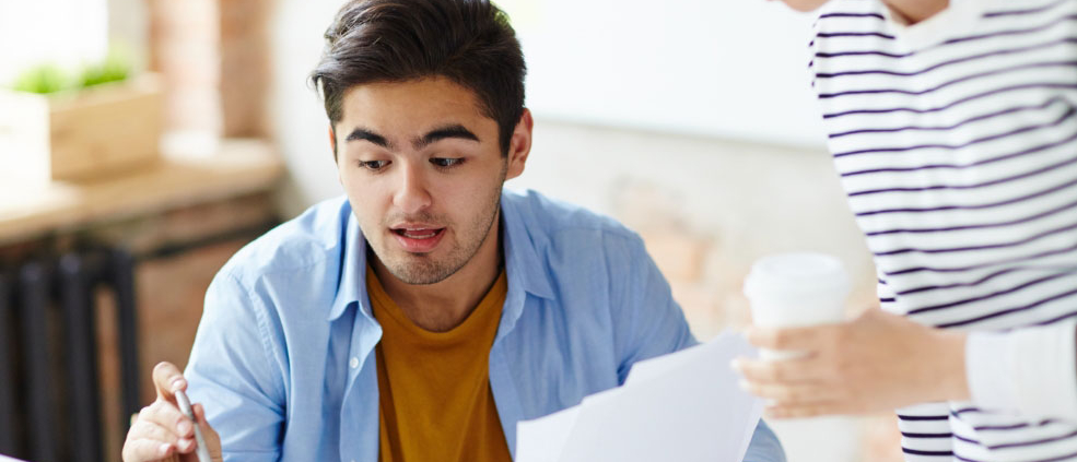 Two colleagues reviewing a financial document together
